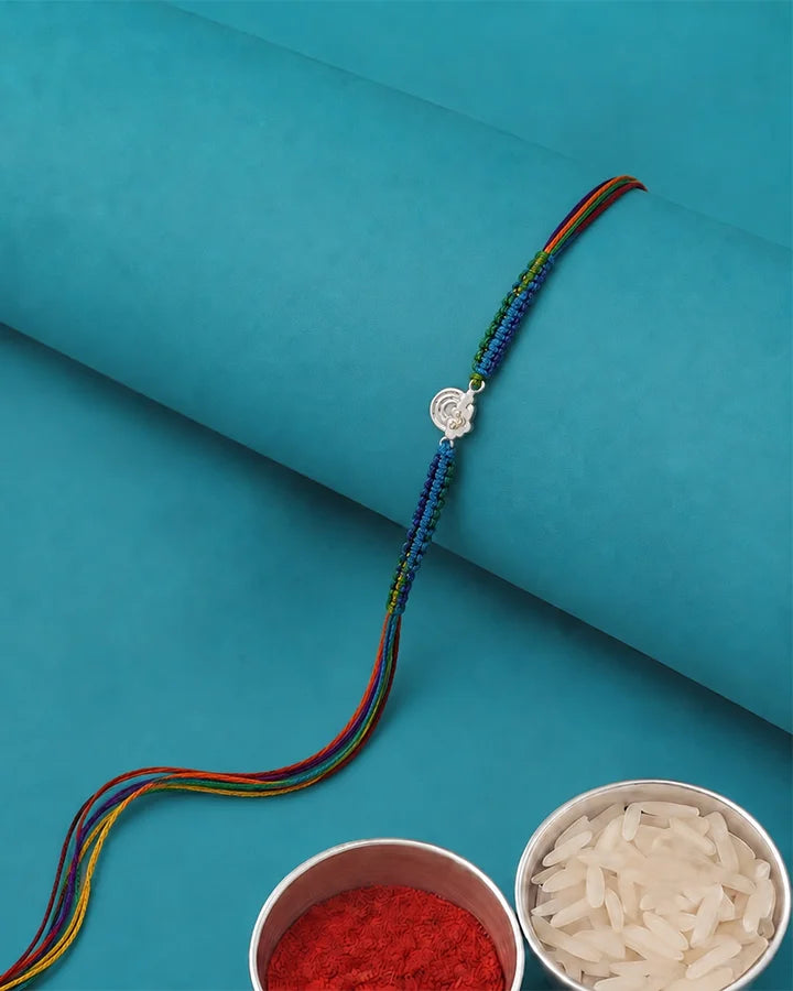 A traditional Indian beaded bracelet (rakhi) with a silver Swastika symbol.